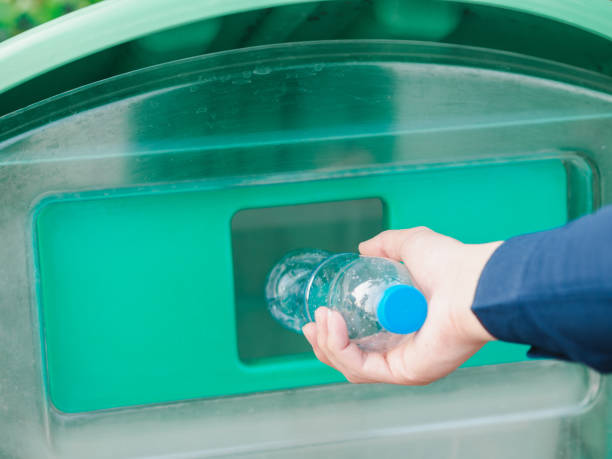 istock Closeup of man hand throwing empty plastic water bottle in a bin. 1137063936