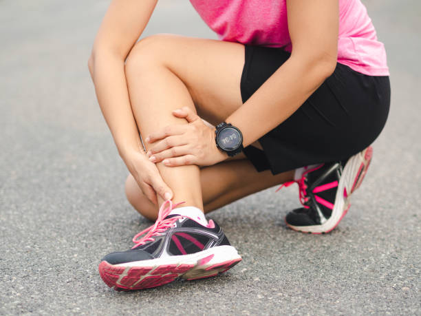 athlete woman has ankle injury, sprained leg during running training. sport concept. - twisted ankle imagens e fotografias de stock