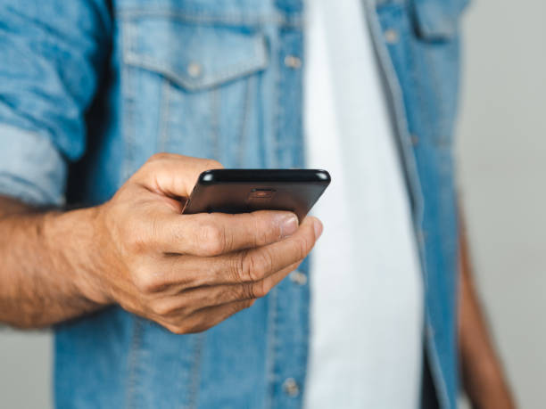 istock Closeup of young man using smartphone isolated on a white background 1137064206