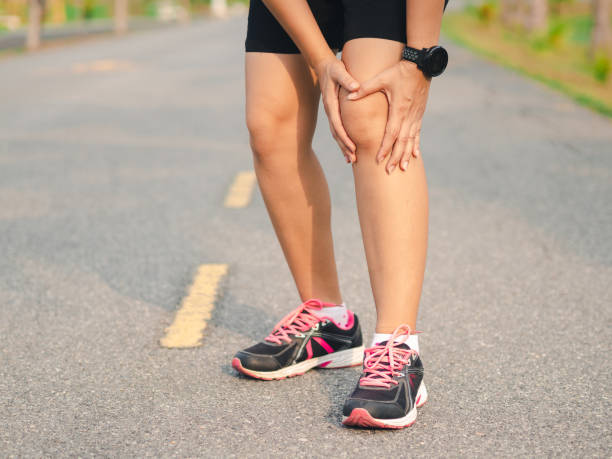 istock Female athlete runner holding her Knee in pain, 1137064486