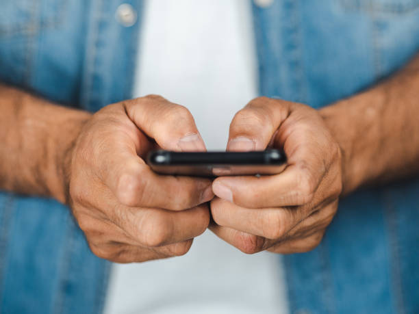 istock Closeup of young man using smartphone isolated on a white background 1137065676