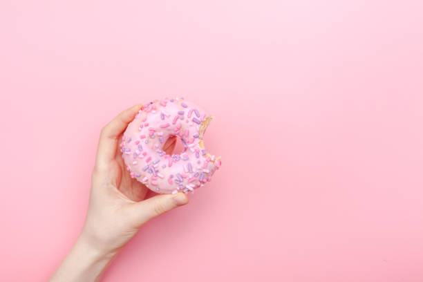 istock donut donuts icing sprinkles on doughnuts pink bright sugar strands 1137065705