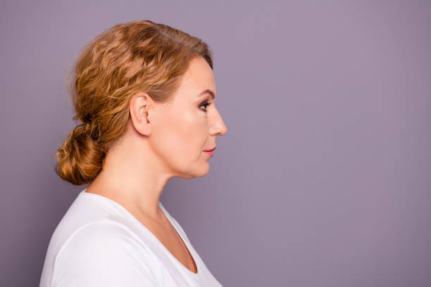 istock Close up side profile view photo beautiful amazing mature she her lady look empty space attentively not smiling pretty hairdo bun curious interested wear white t-shirt isolated grey background 1137066464