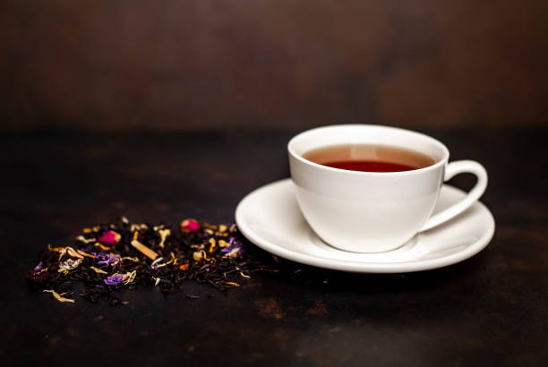 istock tasty tea in a white mug, scattered tea on a stone background 1137069456