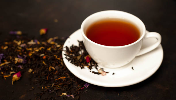 istock tasty tea in a white mug, scattered tea on a stone background 1137069498