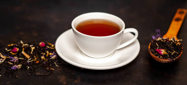istock tasty tea in a white mug, scattered tea on a stone background 1137069513