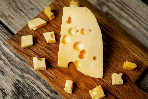 istock delicious cheese on a cutting board, background stone 1137069536