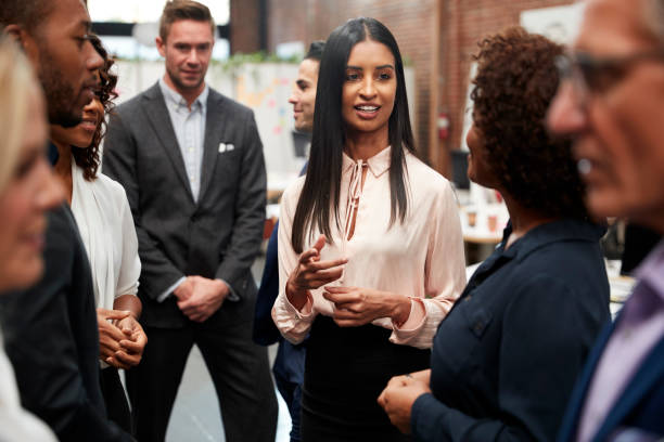 istock Business Team Standing Having Informal Meeting In Modern Office 1137070961