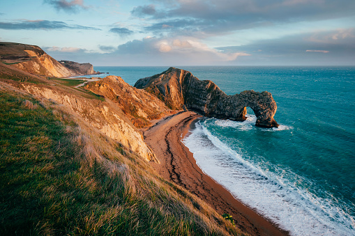 The famous Durdle Door arch in the south coast of UK at sunset