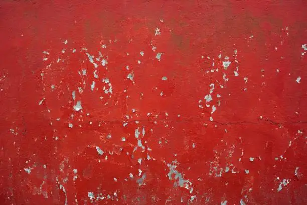 Photo of red peeling paint concrete wall