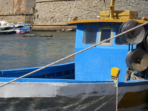 a blue painted fishingboat in the harbor of Gallipoli Italy