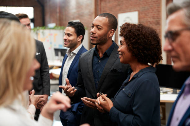 istock Business Team Standing Having Informal Meeting In Modern Office 1137071881