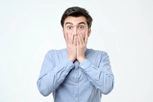 istock Young hispanic man covering his mouth with hand 1137072997