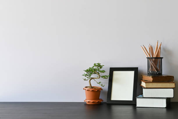 istock Workspace books, pencil, photo frame and bonsai on office desk. 1137074375