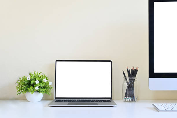 istock Laptop computer and PC on office desk, Workspace with mockup. 1137075349