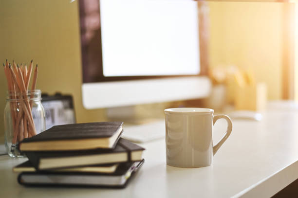Mug of coffee on creative desk.