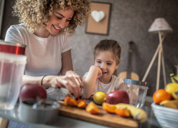 istock Mother and daughter making  smoothie 1137077666