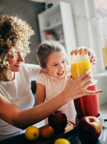 istock Mother and daughter making  smoothie 1137077746