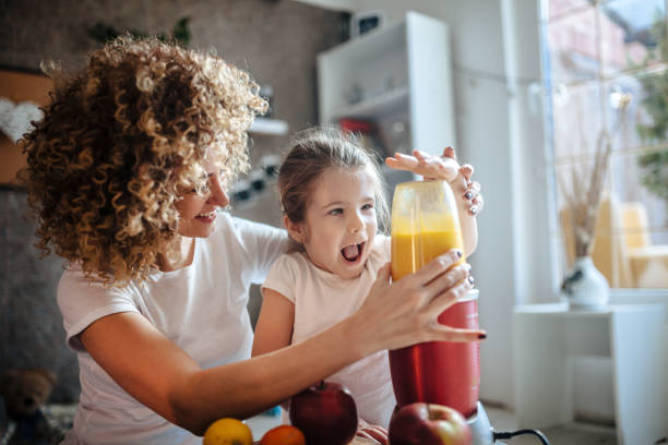 istock Mother and daughter making  smoothie 1137077749