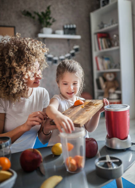 istock Mother and daughter making  smoothie 1137077956