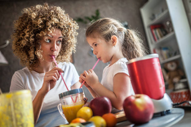 istock Mother and daughter making  smoothie 1137077964