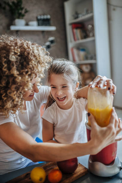 istock Mother and daughter making  smoothie 1137078359