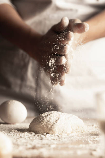Dough Woman kneading dough. baker occupation stock pictures, royalty-free photos & images