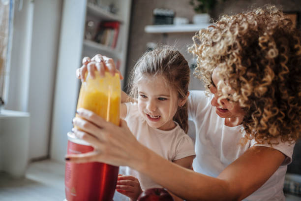istock Mother and daughter making  smoothie 1137078651