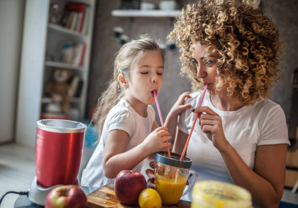 istock Mother and daughter making  smoothie 1137078699
