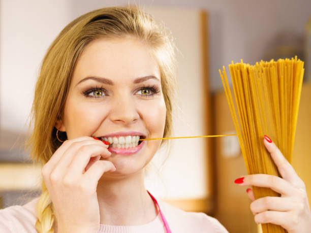 istock Woman holding long pasta 1137078769