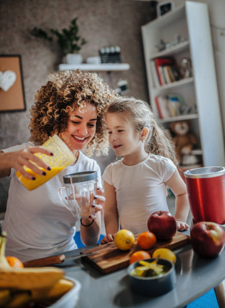 istock Mother and daughter making  smoothie 1137078772