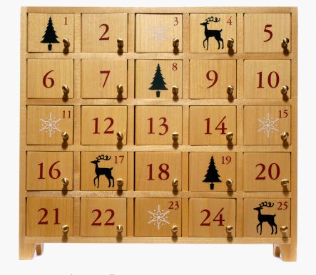 an advent calendar in the shape of a little house with the numbers of the days of December in small drawers, christmas calendar decorated with santa claus and elves and a merry christmas message, vertical
