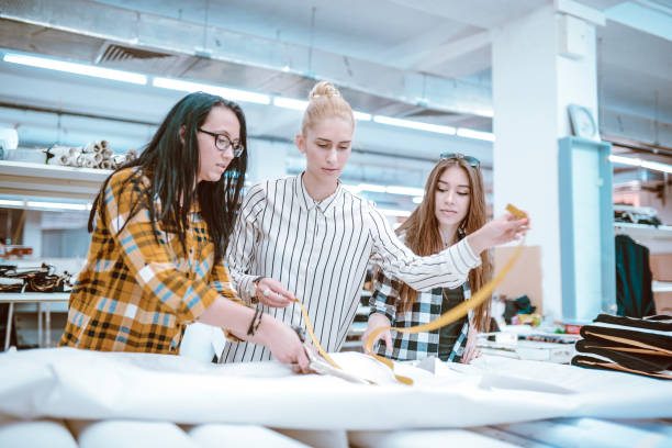 istock Three Female Workers Measuring New Materials In Factory 1137084914