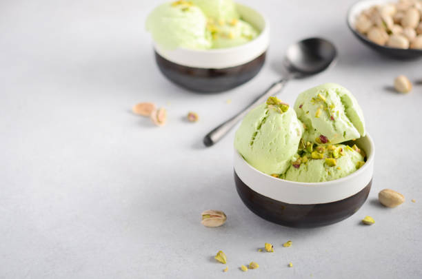 istock Pistachio ice cream in a bowls on a gray concrete background. 1137085420