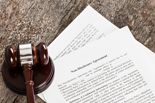 Close up of a generic non-disclosuer agreement with a gavel.