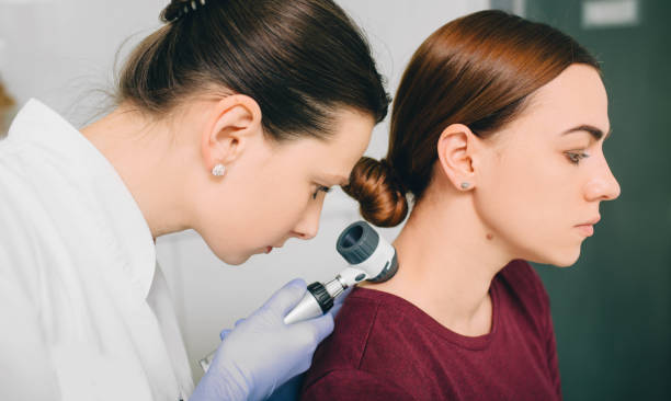 istock dermatologist exam skin mole on female neck using dermatoscope 1137092151