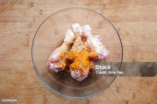 Above View Of Raw Chicken Drumstick Legs With Seasoning And Garlic Stock Photo - Download Image Now
