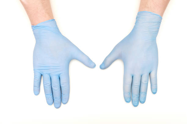 istock Hands in blue latex surgical gloves on white background 1137096450