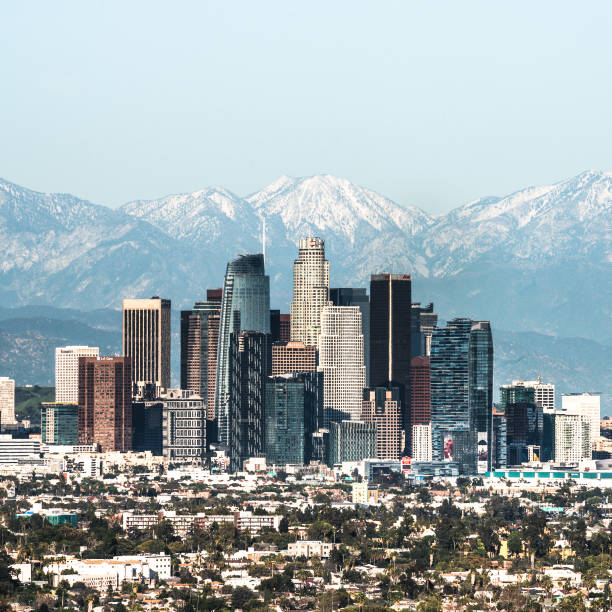 Downtown of Los Angeles against snow capped mountains