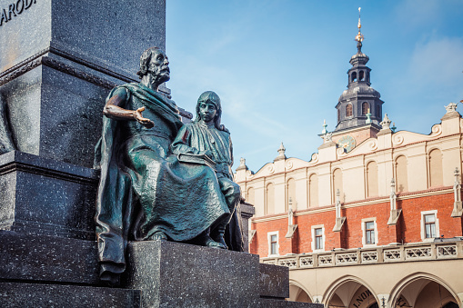 Adam Mickiewicz Monument in Krakow is one of the best known bronze monuments in Poland, and a favourite meeting place at the Main Market Square in the Old Town (Stare Miasto) district of Kraków. The statue of Adam Mickiewicz, the greatest Polish Romantic poet of the 19th century, was unveiled on June 16, 1898, on the 100th anniversary of his birth, in the presence of his daughter and son. It was designed by Teodor Rygier.