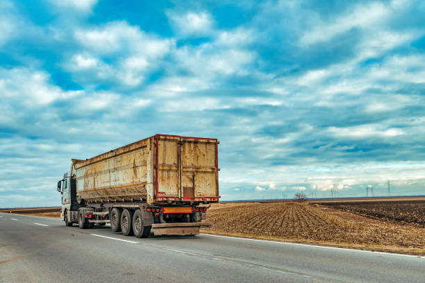 istock Truck on the road through countryside 1137098346