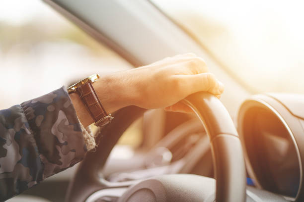 istock Close-up of Man Driving a Car Hand on Steering Wheel 1137101043
