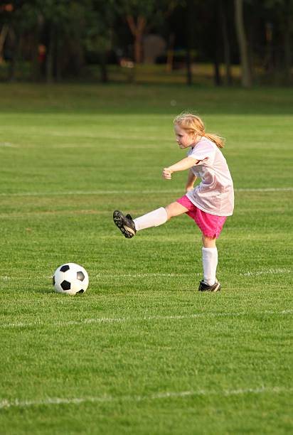 istock girl kicking soccer ball 113710284