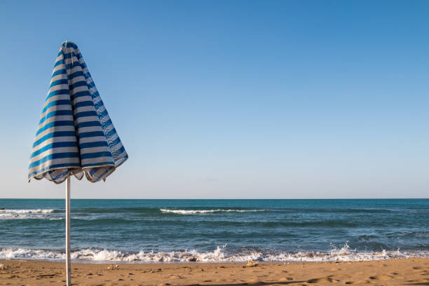 istock Beach umbrella and a sea 1137103273