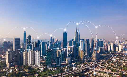 Digital network connection lines of Kuala Lumpur Downtown, Malaysia. Financial district and business centers in smart city in technology concept. Skyscraper and high-rise buildings at noon