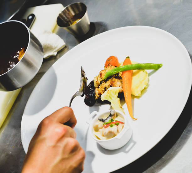 istock Chef preparing food, meal, in the kitchen, chef cooking, Chef decorating dish 1137106837