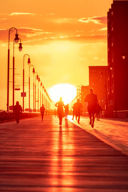 People enjoying outdoor activities under golden light - Long Beach New York