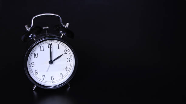 istock Close up image of old black vintage alarm clock. Two o'clock 1137107737