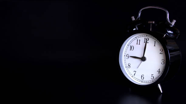 istock Close up image of old black vintage alarm clock. 9 o'clock 1137107785