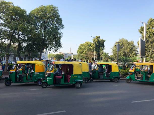 image of indian auto rickshaws taxi cabs, yellow and green tuk tuks transport photo, parked at connaught place, new delhi, india - consumerism indian ethnicity india delhi imagens e fotografias de stock